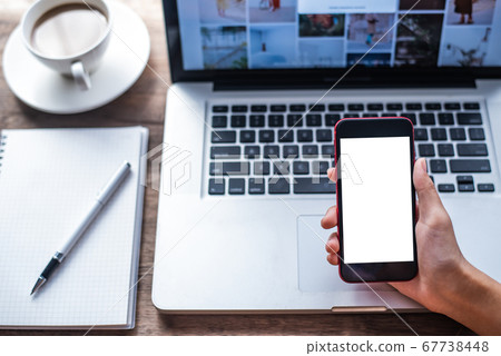 Woman holding blank screen mock up mobile phone Woman holding blank screen mock up mobile phone 67738448