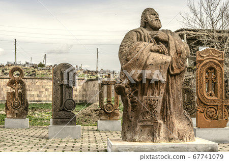 Letters carved from stone and a monument to the founder of the Armenian alphabet Mesrop Mashtots 67741079