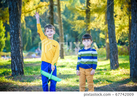 Happy two brother kids playing with toy airplane 67742009
