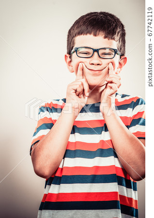 Kid little boy making silly face expression. Kid little boy making silly face expression. 67742119