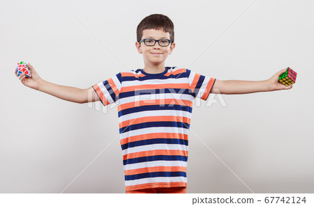 Smart kid little boy with magic rubik cube. Smart kid little boy with magic rubik cube. 67742124