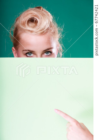 Pin up woman eyes behind white sign Pin up woman eyes behind white sign 67742421