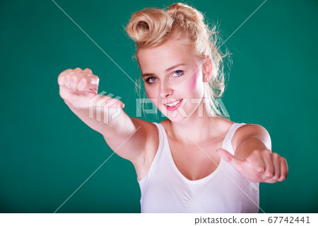 Smiling pinup girl showing thumbs up 67742441