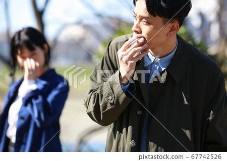Men smoking and hating cigarettes 67742526
