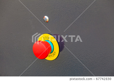 Yellow red emergency button on black machine 67742830
