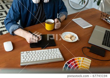 Graphic artist using digitizer Graphic artist using digitizer 67743194