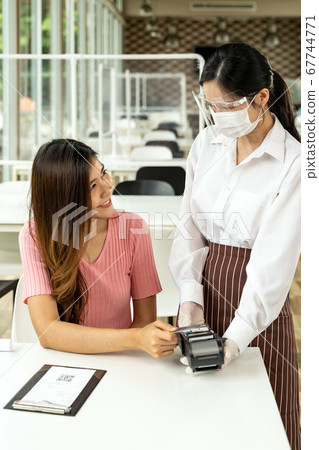 Asian customer make contactless credit crad 67744771