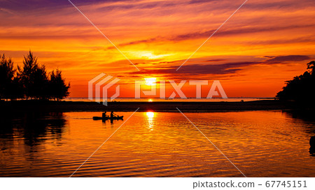 Couple on a row boat during the sunset Couple on a row boat during the sunset 67745151