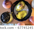 two avocado halves on a plate, three ripe peaches 67745245