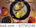 food composition - two avocado halves on a plate 67745246
