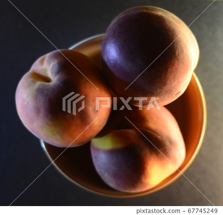 peaches close-up in a file on a dark background 67745249