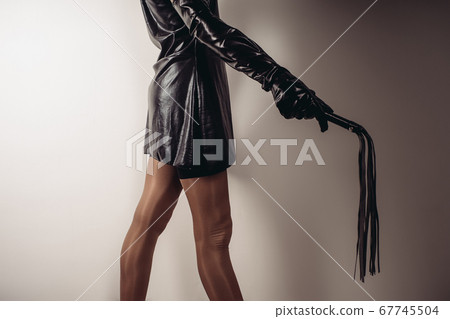 Sensual provocation of a sexy bdsm woman with whip 67745504