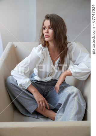 Fashionable young female posing in bathtub. 67747024