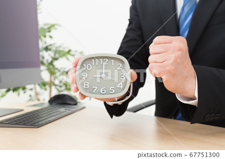 A businessman with a clock A businessman with a clock 67751300