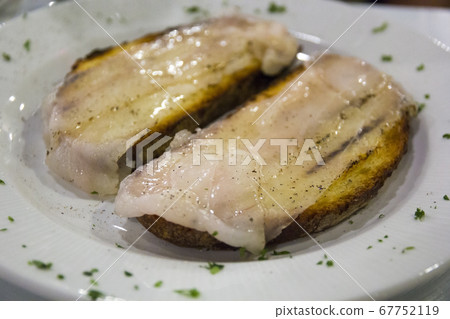 Italian toasted bread with pork lard and pepper. 67752119