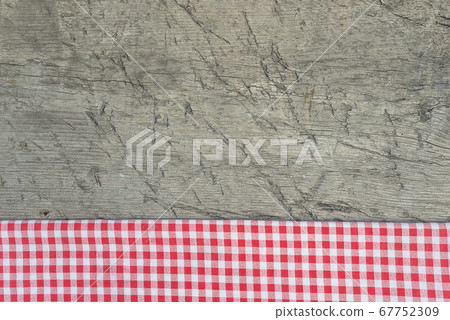 Red and white checkered napkin on rustic wooden planks 67752309