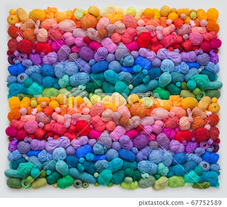 Colored balls and skiens of yarn for knitting. Top view. Rainbow colors. Color horizontal gradient. 67752589