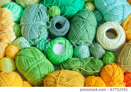 Colored balls and skiens of yarn for knitting. Top view. Rainbow colors. Color radial, round gradient. 67752591