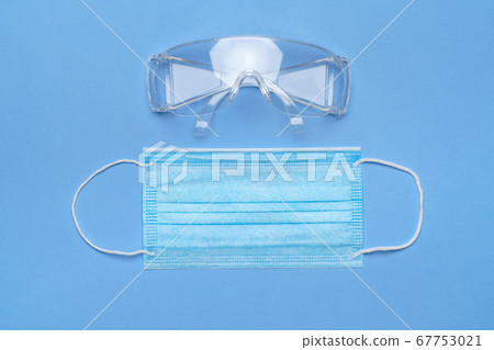 mask and safety glasses for personal protection on blue baclground mask and safety glasses for personal protection on blue baclground 67753021