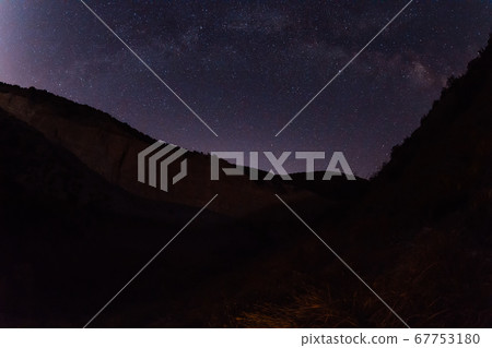 Night star sky with Milky way galaxy and canyon, mountains with trees Night star sky with Milky way galaxy and canyon, mountains with trees 67753180