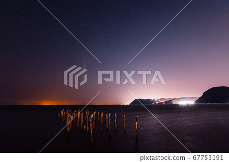 Comet C/2020 NEOWISE at night star sky with sea, birds and city lights 67753191