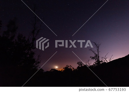 Night star sky with Comet C/2020 NEOWISE and mountains with trees 67753193