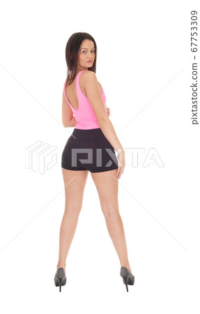 Lovely woman in shorts standing from back 67753309