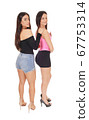 Two beautiful women standing in shorts in the 67753314