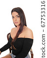 Portrait of beautiful woman sitting in a chair 67753316