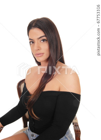 Portrait of beautiful woman sitting in a chair Portrait of beautiful woman sitting in a chair 67753316