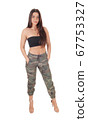 Beautiful happy young woman standing in the studio 67753327