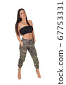 Beautiful happy young woman standing in the studio 67753331