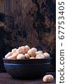 full bowl of hazelnuts on table with copy space 67753405