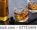 Alcohol drink cocktail with ice cubes. whiskey or 67753409