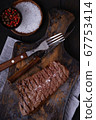 Grilled beef steak with knife and fork on cutting 67753414