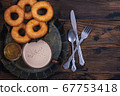 Donuts and jam with coffee cup on wooden table 67753418