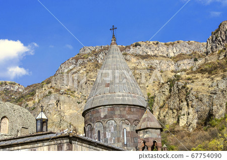 All domes with crosses and a cave church with carved khachkars on the walls, in the Geghard monastery in Armenia All domes with crosses and a cave church with carved khachkars on the walls, in the Geghard monastery in Armenia 67754090