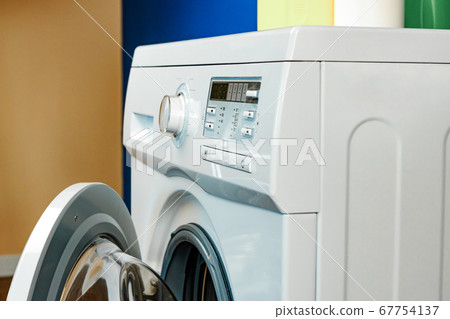 Close up of washing machine in bathroom. 67754137