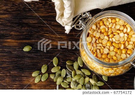 Raw cereals or beans in glass jars close up. Vegan and vegetarian food. Raw cereals or beans in glass jars close up. Vegan and vegetarian food. 67754172