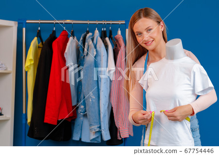 Close up photo of a seamstress at work 67754446