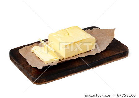 Butter on wooden board isolated on white background 67755106