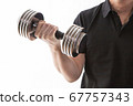 A man doing muscle training in his home room using dumbbells A man doing muscle training in his home room using dumbbells 67757343