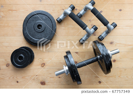 Dumbbell and push-up bar on the floor at home 67757349