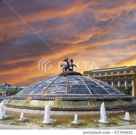 Manege Square (Glass cupola crowned by a statue of Saint George, holy patron of Moscow) on a cloud background. Inscription in Russian 67764685