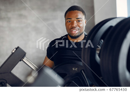 A handsome black man is engaged in a gym 67765430
