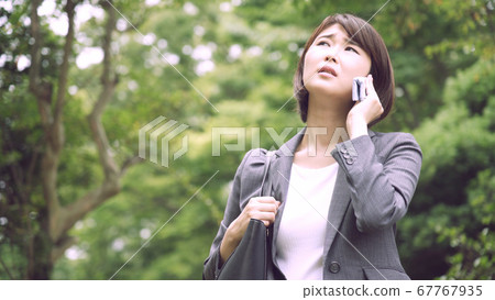 Wiping sweat business woman 67767935