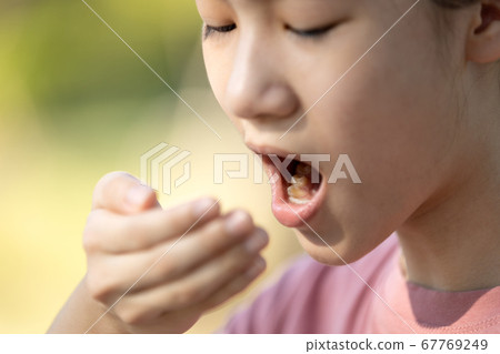 Child girl checking breath with her hand,woman doing a bad breath test after have breakfast,foul mouth from inside the tongue,teeth and gums,oral bacteria problems,halitosis,health care,dental concept Child girl checking breath with her hand,woman doing a bad breath test after have breakfast,foul mouth from inside the tongue,teeth and gums,oral bacteria problems,halitosis,health care,dental concept 67769249