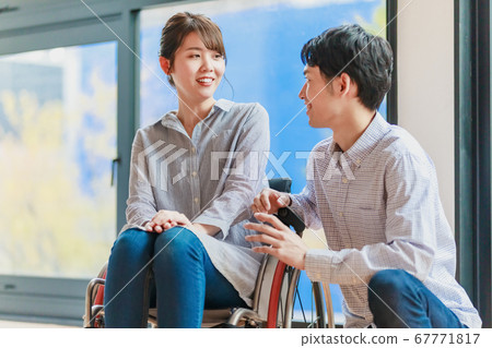 Woman and man couple in wheelchair 67771817