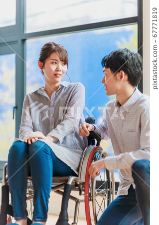 Woman and man couple in wheelchair Woman and man couple in wheelchair 67771819
