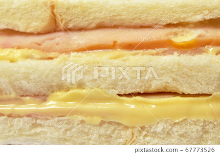 close up of sandwich stuffed ham and cheese on white background 67773526